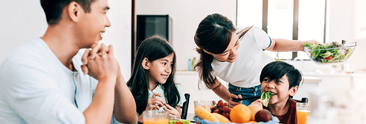 family of four enjoying a meal together