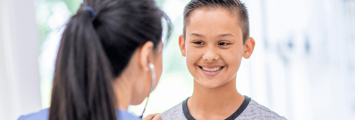 female doctor with young boy patient