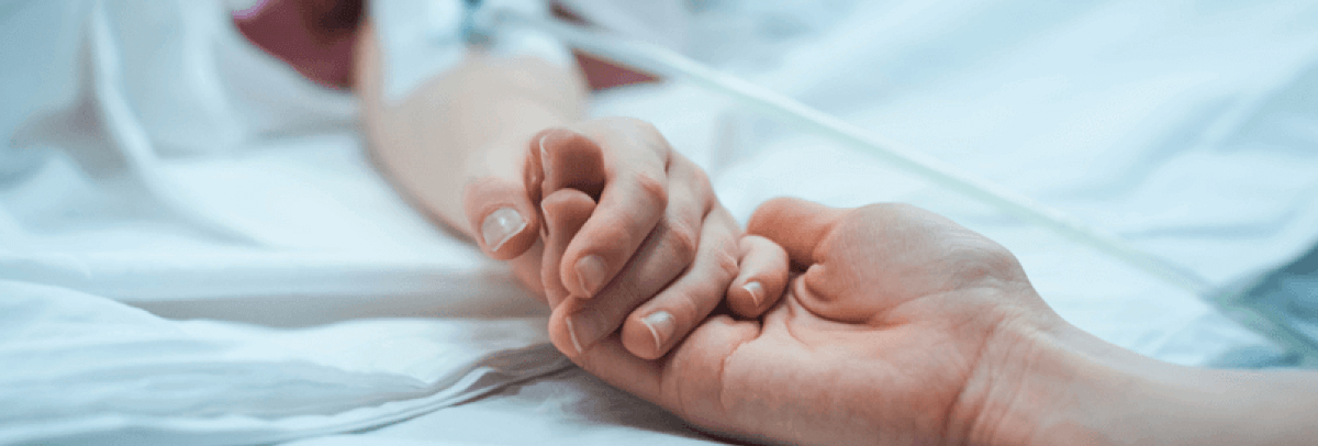 Holding hands while in hospital bed